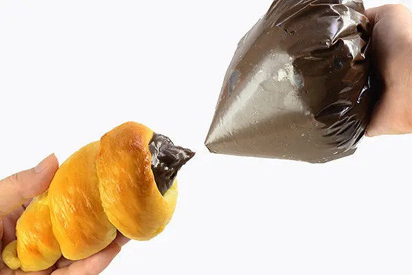 Place chocolate cream filling from step 4 in a thick plastic bag. Cut the corner of the bag and squeeze into each hole of bread until full.