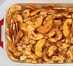 Prepare the filling. Peel, core, and slice the apples. Combine cinnomon, brown sugar, butter, flour, lemon juice and toss with apples until evenly coated.