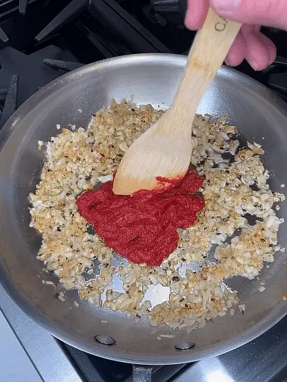 Add tomato paste in middle, cook a few minutes