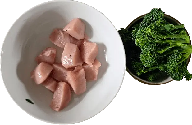While the rice cooks, cut the chicken into bite-sized cubes and the broccoli into small florets.