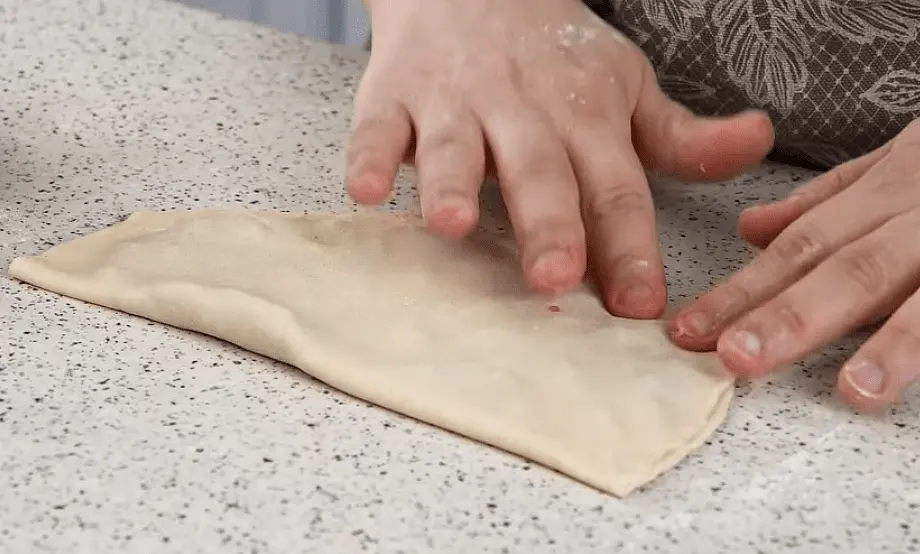 Wet the sides of your dough with water and close the dough shut then press with your hands to seal. Do the same for the rest of your dough.