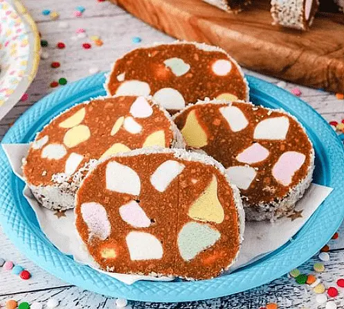 Warm butter and condensed milk in microwave. Add malt biscuits and fruit puffs. Make into a log, roll in coconut and in fridge to set, about 4 hours.