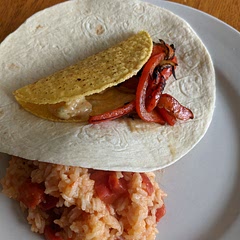 Really a good idea. I used corn shells inside of flour tortillas and loved the taste. I've altered the recipe to reflect my feeling that cooking the onion before the red pepper is not necessary, and to make clear that the sauce should be included when adding the shrimp to the pan. The rice and tomatoes was a fine go-with. There are lots of ways to change up this meal and it will be on my regular rotation.
