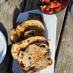 This is one of my favorite summer tomato recipes! This simple, raw tomato sauce works great with grilled bread (did this while camping!) like a bruschetta, but also tasty with pasta or over fish/chicken. Quality of tomato is important because they are the star! I also like experimenting with mix ins (olives or capers). Very adaptable.