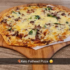 Was a great first attempt! poking holes in it with a fork definitely worked the magic not having it bubble up. it was weird that with keto fat head dough you cook the base before adding the ingredients. This was grainy and cheese overload! however it wasn't that bad! I would have this in small doses.. perhaps Mini Pizzas!