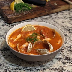 So delicious! Made it on a budget for two with frozen tilapia fillets and shrimp (both of which we keep around), and a dozen littleneck clams. I used seafood stock instead of clam juice, and omitted the water in favor of extra pinot grigio and stock. I also included smoked paprika, and a sprinkle of sugar to balance the acidity. Lemon juice squeezed over top, and served with crusty baguette and quality butter. Super forgiving and customizable dish to make exactly to your tastes— next time I'll use extra fennel, switch up the seafood, and try with red wine instead of white.