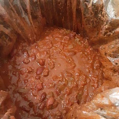 I cooked it w/ a crock pot cover so clean up is much easier. I also added green & red bell peppers & extra chili powder. Completely yummy.