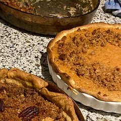 The sweet potato pie is In the white dish. Very tasty, not too sweet! I topped it with a pecan and crushed ginger snap streusel.