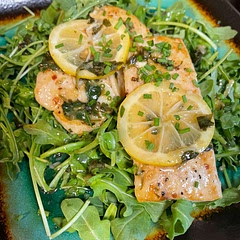 I put it over arugula and topped with fresh chives and some of the leftover sauce from the pan. (I put the parsley in with the butter and lemon slices to draw some more flavor from it.)