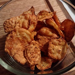I used a KitchenAid slicer attachment and let the potatoes soak overnight. For the seasoning I used garlic salt, pepper and paprika. With only a single layer my air fryer only needed about 2-3 min at 400⁰.  They do become soft after being stored for just a few hours so it would be best to eat them right away.