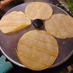 You can steam the tortillas directly over the meat while it cooks, using a splatter screen.