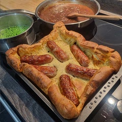 Best toad in the hole recipe! Turns out perfect every time. The red onion gravy is a MUST. I add rosemary to the oil to cook with the sausages