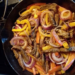 I put the seasoning in a quart bag with the beef and put it in the fridge for a few hours. Then I cooked the beef first, removed it from the skillet, and sautéed the peppers and onion in the pan without cleaning it. Get all that beef flavor and the spices that came off onto the vegetables. Then back into the pan went the beef, to finish cooking.
