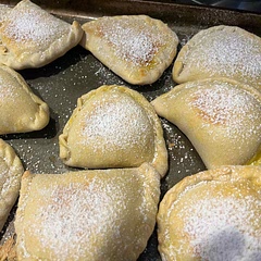 I baked them at 350 degrees for 21 min. I accidentally used bread flour and also accidentally left the dough balls out overnight so my dough was thicker than it should have been but they taste delicious. Next time use all purpose flour and roll the dough out thinner. Also use an egg wash to seal the edges.
