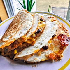 I sprinkled about a cup of extra cheese into the bowl with the bean and corn mixture. I also sprinkled cheese on the tortilla before adding the corn mixture and onto the beans before folding tortilla over. I tried using the 2 tortilla method but preferred using one and folding over like a taco, as another commenter mentioned.
Best when left to cook until browned-don't be scared.