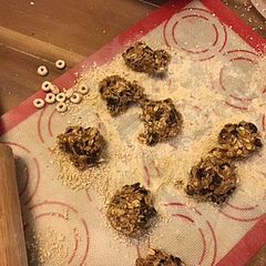I rolled the final balls in crushed cheerios to make them not as sticky. Kids have already asked me to make more.
Gloved hands make it much easier to form the balls from spoonfuls.