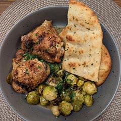 Chicken thigh cooked in the oven 
Add sprouts when approx 20 min of chicken time left 
Serve with garlic flatbread 