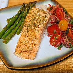 Instead of cooking the salmon in the pan I baked it in the oven. Also I slightly sauteed the tomatoes and onions and mixed it in with a little bit of lemon and parsley after it was done cooking. For plating I made a small portion of rice, also because my friend wanted rice.
