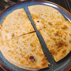 I left the stray bean on the quesadilla, but that's part of the process. The whole thing turned out so good, my daughter loved it and so did my husband. I would recommend adding cheese first, then spoon in the mix and then sprinkle on another layer of cheese so when you flip it, the cheese is thoroughly melted bonding the two tortillas together.
