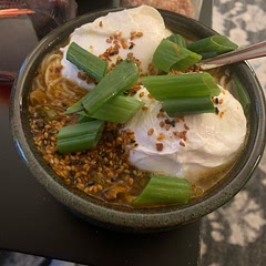Fry mushrooms first, poach instead of soft boil the eggs, reduce amount of broth, omit the bok choy to stay on a budget, add some spring onion garnish and some finishing seasoning.

Putting color on the mushrooms enhances the flavor.