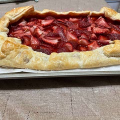 This recipe was simple and lovely. I didn’t want to roll it much so I made it rectangular, hope that doesn’t break some rule lol.
Our local store had a deal on strawberries only. Just pulling it out of the oven I was struck by the other gorgeous fruit possibilities. The filling set perfectly, so if you’re like me and you get worried at the liquid in the berry mixture, rest assured it all works out in the end. I did do one slight variation. I had some zest left so I mixed it with some sugar for the bottom of the galette. 
I cannot wait to try this, but it looks so pretty.