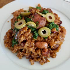 Added some fried beef sausages, but would probably be better with Choritzo. Needed an extra cup of water as started sticking to the pan after about 10 minutes of simmering. Quite tasty. 