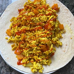 a staple, easiest tofu scramble recipe ever. all you really need is the tofu and the seasoning blend and the rest you can improvise to your tastes. i've topped it with sriracha, salsa, guac, etc.