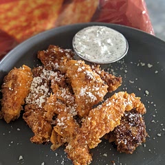 In the flour I added pepper, garlic powder, and salt. I didn't use any milk. I fried it in Cheyenne pepper infused oil. Then sprinkled some crumble cheese and served it with a Dill Greek yogurt dip. Turned out great! 