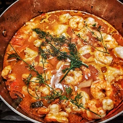 Had to make a few substitutions, red rather than white wine, clam juice rather than fish stock, and added veggies that needed to be used. Came out okay although seasoning was tricky. I've eaten this in Portugal and it's true to form. 