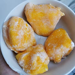 be warned: the dough gets very sticky!it was hard to flatten it and wrap the mango pieces but it was very tasty. i added some orange food coloring. some practice does wonders though :) 
