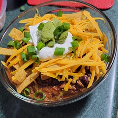 A delicious fall meal for those 'chili' nights.  ☺️ A bit of cocoa powder - A tradition at home. Topped with frito chips for my sweetheart.  