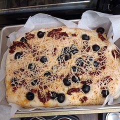 I added black olives, sun-dried tomatoes, and shredded parmesan cheese. Delicious.  I had cooked it for 10 minutes more. I should've cooked it longer though. Either that, or next time, I'll split the dough between 2 pans so it won't be so thick. 