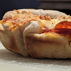 Started in a cast iron skillet on the stove top to crisp up the crust. Then placed the whole skillet in the oven at 500° to cook the pizza.