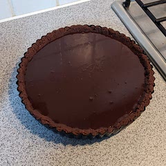 This was really easy for such a tasty and  polished dessert. I only did the recipe for the chocolate filling, I used a tart crust from another recipe. I forgot to add the sea salt flakes for the photo. 

The crust I made: For the crust I threw 300 grams of bourbon chocolate biscuits in a food processor with 50g of dark chocolate and mixed it with 80g of melted butter.  I then compressed it in the tin. It held together lovely.  