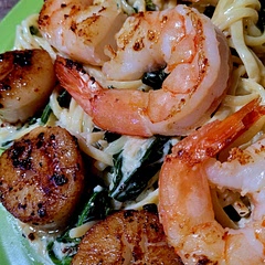 Doubled the sauce and added fresh spinach. Also added scallops and served over fettuccine. Served with French bread. Cooked the sauce separately and cooked the seafood separately as well. Mixed together and viola! Excellent flavor  and texture.