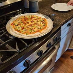 Def use rolling pin for even crust. Also make sure the crust edges have the oil in order to brown that area. 
We added mushrooms, green pepper, pepporini and both mozz and Parm cheeses. Delicious!! 
