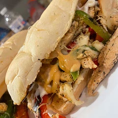 Cook chicken, throw peppers and onions (mushrooms if you like) in the pan with chicken, put cheese on top and cover with lid so it melts. Scoop straight into bun. Top with mayo or Dijon mustard (or mustard of choice)