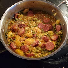 I used peas and andouille sausage instead of the spinach snd smoked sausage. For the tomatoes I used 🍅 paste. It came out creamy and spicy.