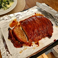 Beef & pork mince meat loaf, wrapped in bacon, blended carrot, peppers, and shallots with bbq seasoning to make it my own.

low and slow smoked for 2.5hrs,
Glazed with bbq sauce every 40mins

wife and toddler approved!