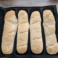 I didn't have a large enough sheet pan to fit under my sub bread mold to lay completely flat. So some baked a little bit together and they are slightly curved. But still turned out really good. I didn't do the topping yet, but it's good by itself. Super soft, pillowy, and perfect! 10 out of 10