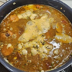 Used 2 ham hocks since i couldnt find pickled pork shoulder, and went with .75 tbsp cayenne. Had to cook for around 3.5 hours to get to a good consistency (picture taken about an hour in). The beans are so full of flavor and the sausage melts in your mouth. This recipe is definitely worth the effort