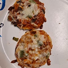 Used regular biscuits (rolled flat), BBQ sauce mixed with pizza sauce, green peppers, leftover bbq pork, pepperoni, onion, mushrooms, fresh basil, and mozzarella cheese. Cooked 13 min on 350. A nice spin on traditional pizza.