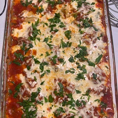 Added about 3/4 of lbs of medium Italian sausage. I cooked onion with sausage and then added to cheese mixture. I also used almost a whole additional jar of marinara. Turned out great!