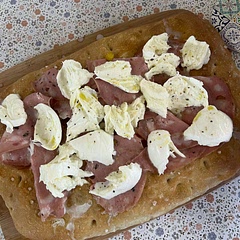 First time baking a focaccia. Served this as starter between 4 people (serves 10 measurements). Super crispy and delicious. Truffle infused mortadella, burrata and truffle oil were 💯