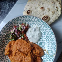 This has fast become a favourite in our house, we leave out the chilli and it serves all ages. Served with Kachumber salad and a homemade raita, the naan goes down especially well