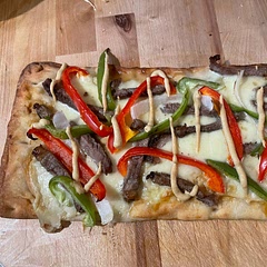 We actually went Philly cheesesteak themed for ours. 
Honey & mustard base, mozzarella discs, steak, peppers, onion. Drizzle of mustard and honey