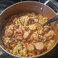 Cooked the rice separately. Used 3 tablespoons of red wine vinegar instead of white wine. Didn't add any red pepper  flakes. Put the peppers in after the beans and let it simmer. Delicious!!! My family loves it. I've been in a rut cooking the same stuff over and over again. I found this app, and this is the first recipe I've made. I'm super happy! 