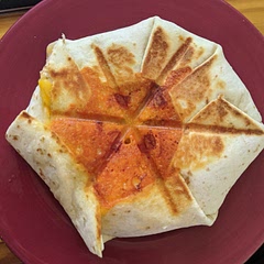 I used the biggest tortilla I could find and a quesadilla maker to press it. They take time to assemble, but are really delicious when home made. Great "work from home" lunch 