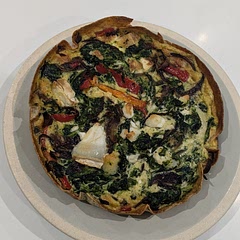 Nice idea to use a tortilla, but it does come out a bit wet on the bottom. Still tasty, but I wouldn't choose a tortilla over short crust pastry. 

I used wilted spinach, a sweet pepper, caramelised red onion and goats cheese as my filling. 