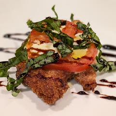I decided to pound chicken thin, fry, and serve with balsamic glaze. 
Coat in flour, dredge, and coat in panko bread crumbs. 
De-seed tomato slices, layer over cheese and bake. Add basil and sweet balsamic glaze before serving.